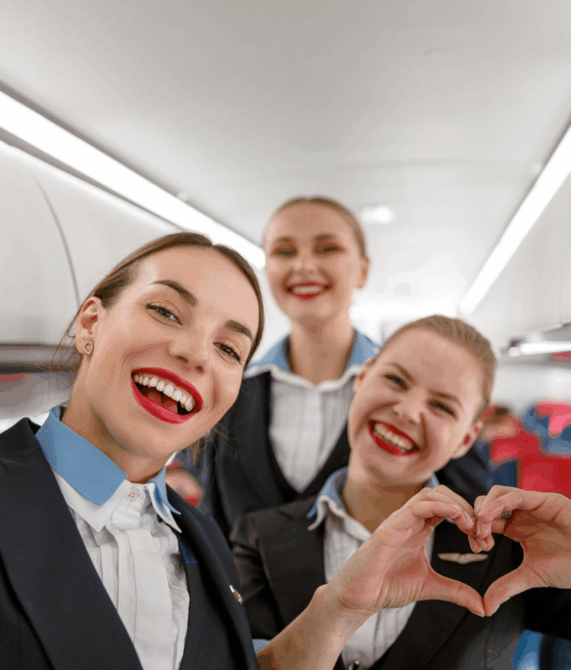 Flight attendants enjoying their work during a commercial flight