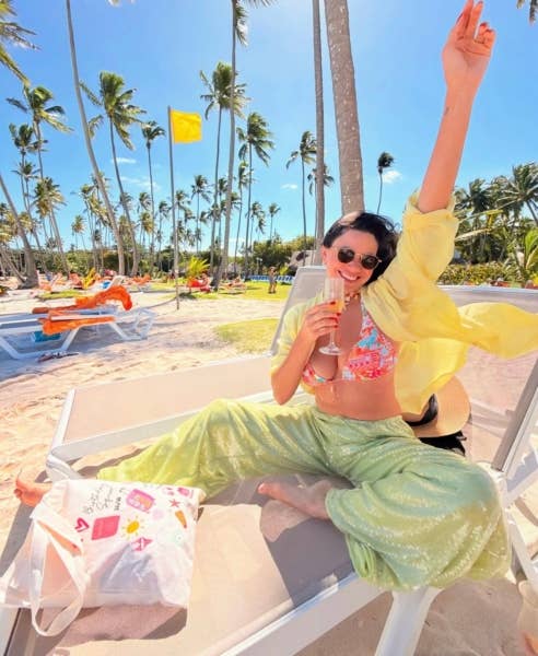 ID90 Travel member celebrating on a beach.