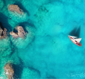 Oahu with clear turquoise water, and rugged rocks nearby.