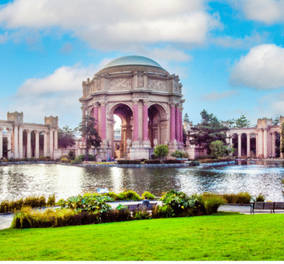 Open-top tour bus driving through San Francisco with city landmarks in view