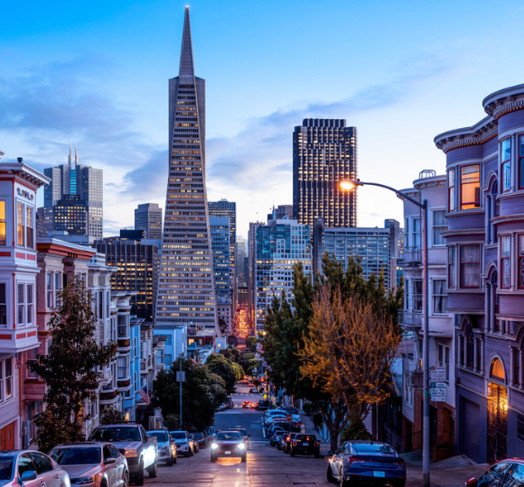 San Francisco skyline with skyscrapers, rolling hills, and waterfront along the bay