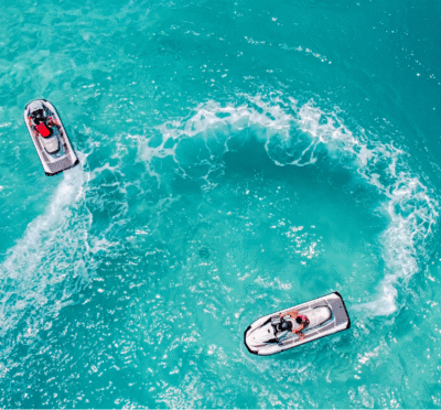 Jet ski rider speeding across turquoise waters with the Miami skyline nearby