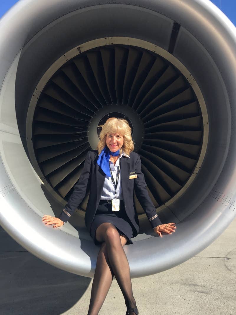 Airline employee posing in front of a jet engine