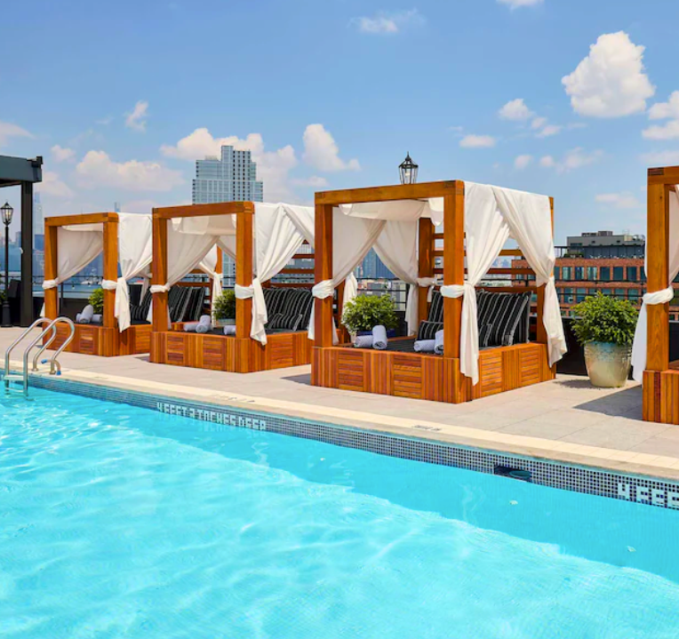 NYC turquoise pool with city skyline at the Arlo Hotel Williamsburg