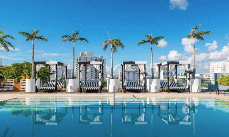 Exterior view of Liberty Park Hotel with palm trees and classic Miami-style architecture