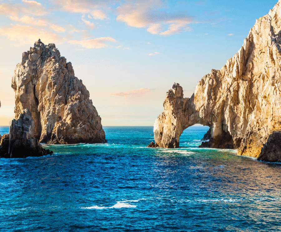 Rock formations of the iconic Cabo arches rising from the ocean near Land’s End