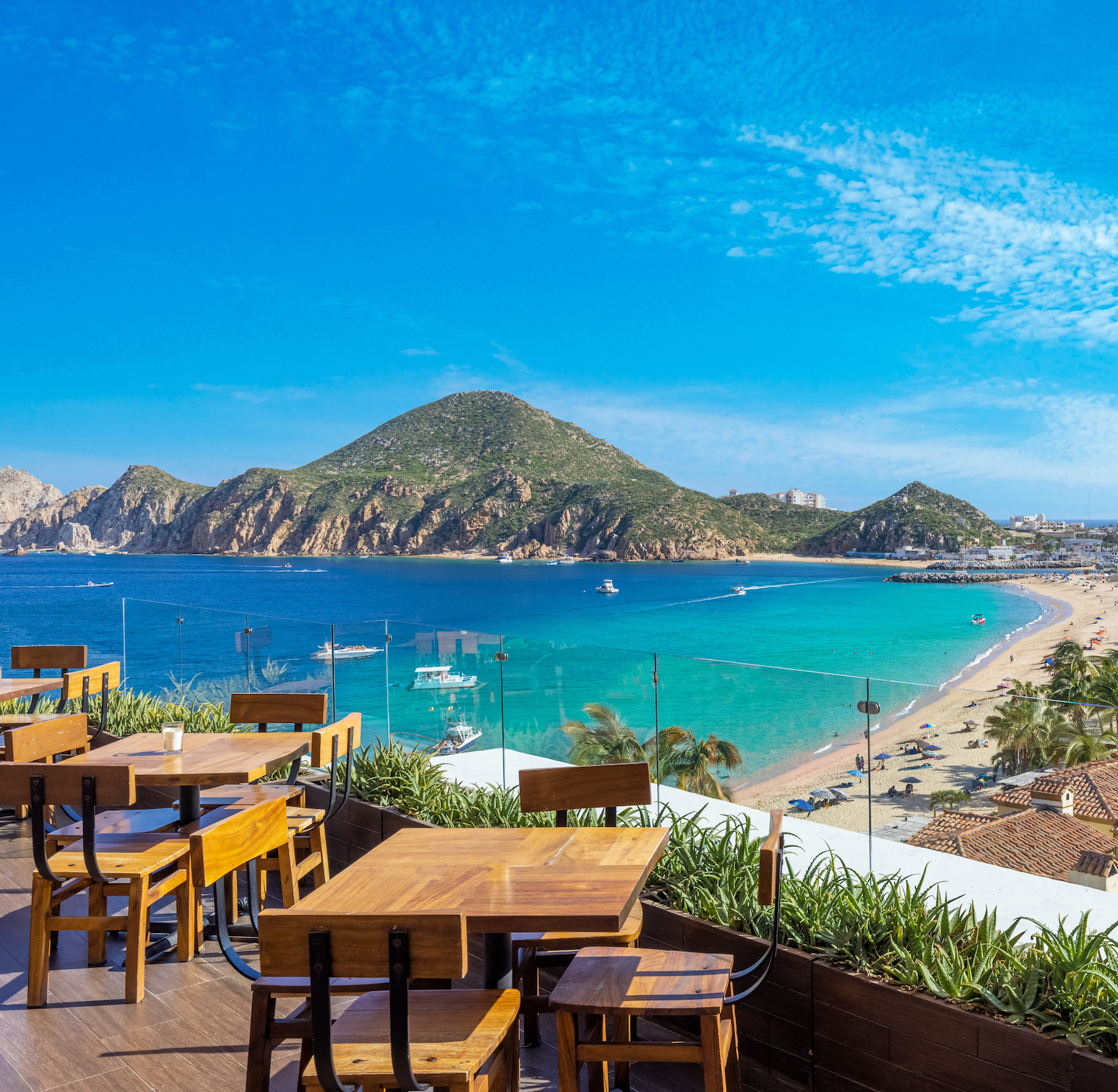 Rooftop terrace with lounge seating and a clear view of the sandy beach and ocean
