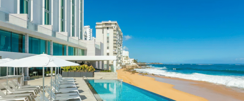 Outdoor pool area at Condado Beach Club with ocean views and stylish seating