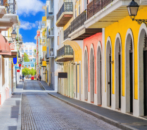 City view of San Juan buildings with colorful facades and coastal skyline in the background