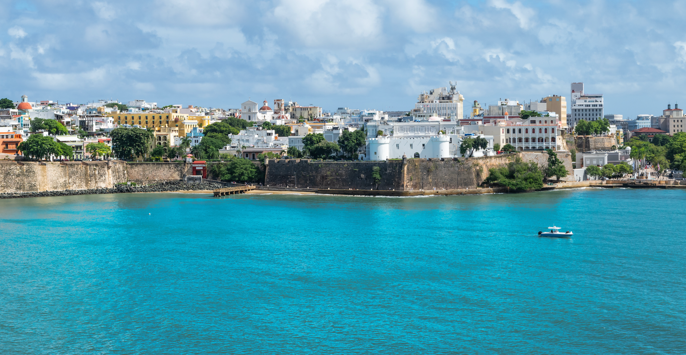 Bright blue ocean water meeting the horizon under a clear tropical sky