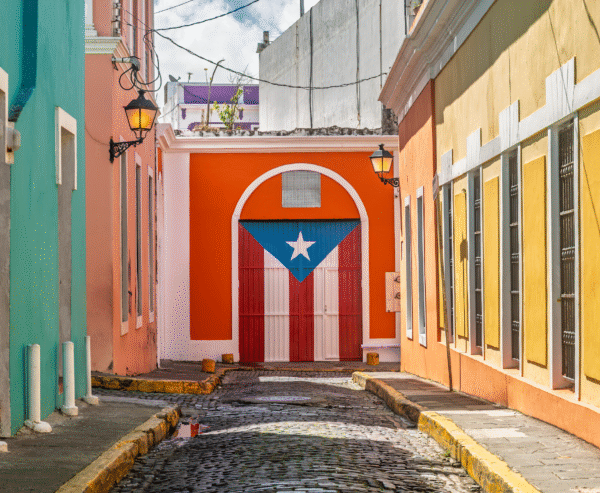 Colorful colonial buildings in Old San Juan with the Puerto Rican flag displayed proudly