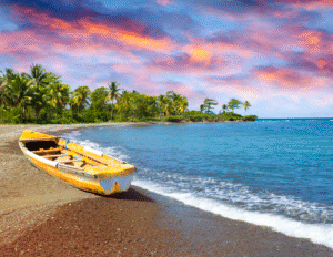 Colorful sunset over a Jamaica beach with a small boat resting on the shore