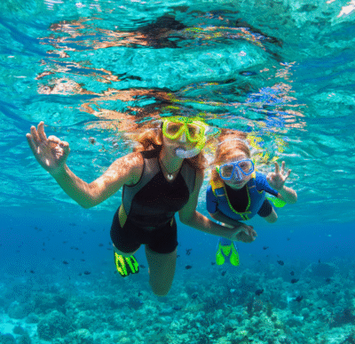 Snorkeler exploring clear blue waters over coral reef in Jamaica