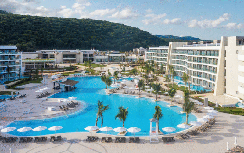 Modern beachfront view of Ocean Coral Spring hotel with large pool and ocean beyond