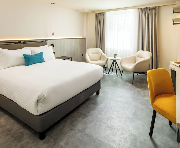 Spacious Orlando hotel room with comfortable bed and natural light