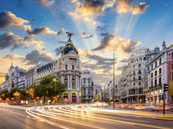 Madrid city skyline with historic and modern buildings under a bright blue sky