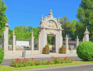 Peaceful Madrid park with green lawns, walking paths, and shaded trees in an urban setting
