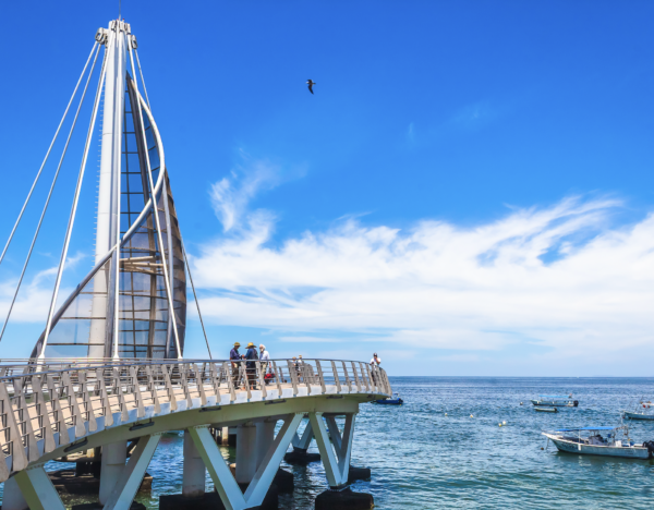 Iconic pier extending into the ocean with sail-shaped sculpture and sunset views