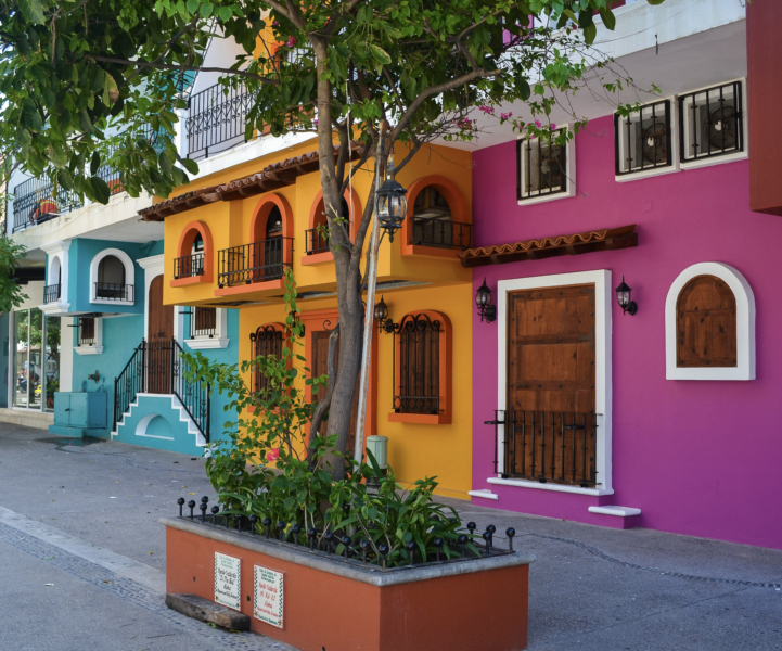 Colorful cobblestone streets lined with bright buildings and local shops