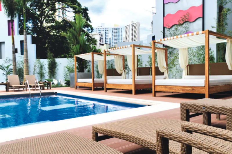 Exterior of Hotel Riu Plaza Panama towering above the city skyline.