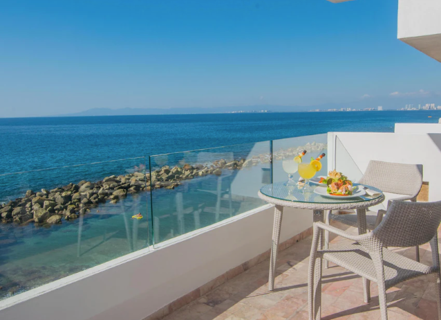 Oceanfront resort with terraced balconies overlooking a secluded beach in Puerto Vallarta