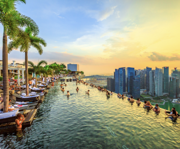 Rooftop infinity pool overlooking Singapore skyline at sunset