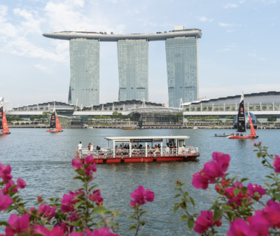 Cruise boat tour passing Singapore Marina Bay skyline