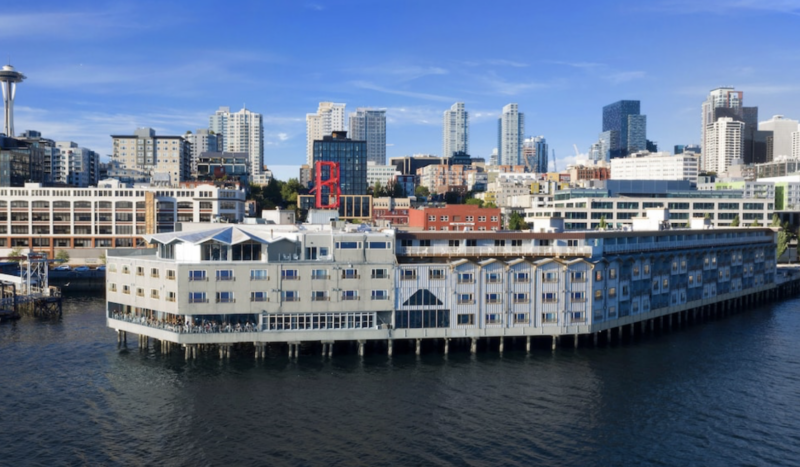 Edgewater Hotel perched over the water with wooden exterior and views of Puget Sound