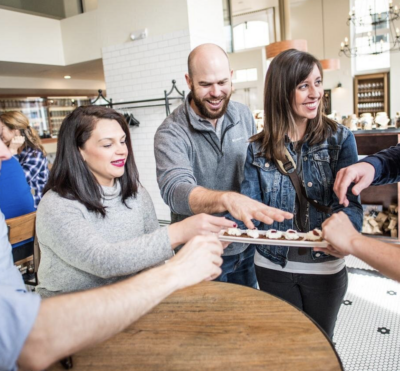 Food tour with people sampling local dishes