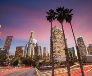 Aerial view of Los Angeles skyline during sunset with glowing city lights