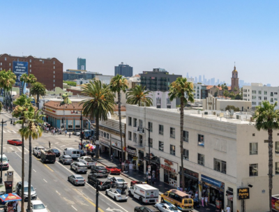 Tour bus driving through Hollywood with sightseeing passengers