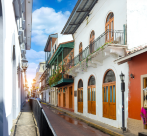 Busy Panama City street with cars, shops, and everyday urban life.
