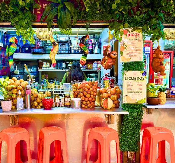 Colorful juice bar serving freshly blended fruit drinks in Mexico City.