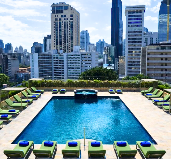 Exterior of Waymore Hotel in Panama City surrounded by modern city architecture.
