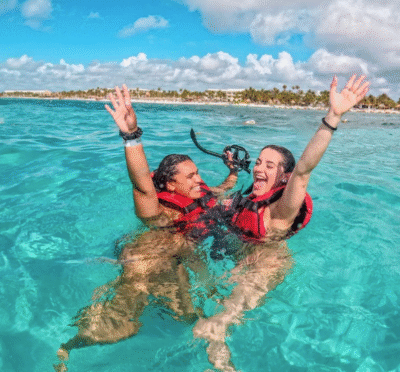 Two women snorkeling in clear water on a sea turtle snorkeling