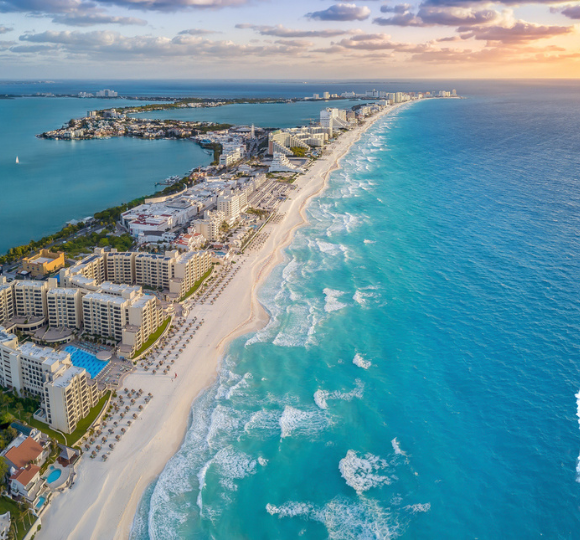Aerial view of Cancun’s Hotel Zone with white sand beaches and turquoise Caribbean waters lined with resorts