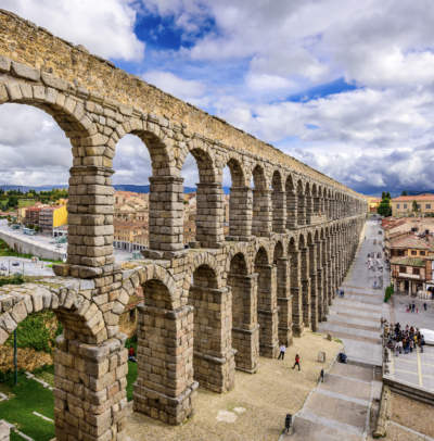 Historic Roman aqueduct and medieval streets in Segovia during a day trip from Madrid