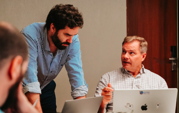 Mike Stacey, CEO, speaking with members of the leadership team in a meeting setting