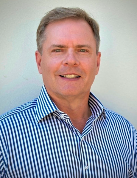 Professional headshot of Mike Stacey, CEO, facing the camera with a confident expression in a corporate setting