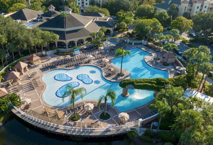 Sheraton Vistana Resort Villas pools and resort view, surrounded by palm trees.