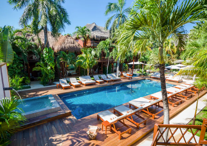 Magic Blue Spa Boutique Hotel-Adult Only pool with luxury style loungers and palm trees.