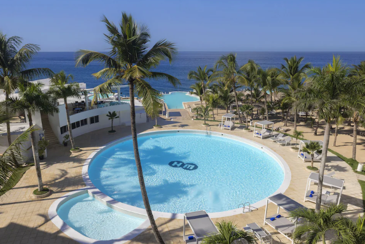 Hotel HM Alma pool and beach scene with clear waters